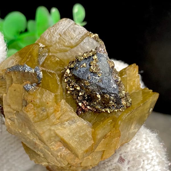 Grey tetrahedrite and brassy chalcopyrite in golden-brown siderite — detail view