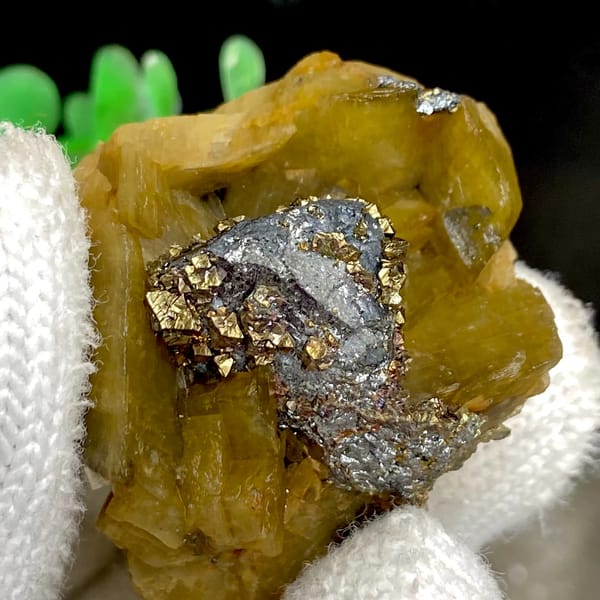 Grey tetrahedrite and brassy chalcopyrite in golden-brown siderite — detail view