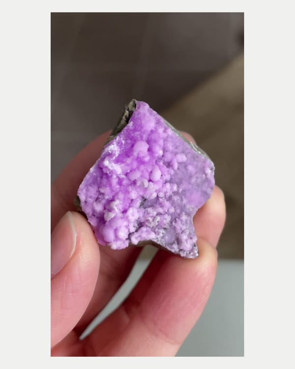 Complete front view of purple aragonite crystal cluster