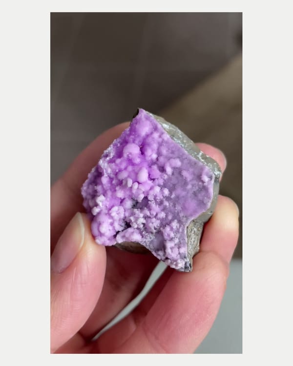 Complete left oblique view of purple aragonite crystal cluster