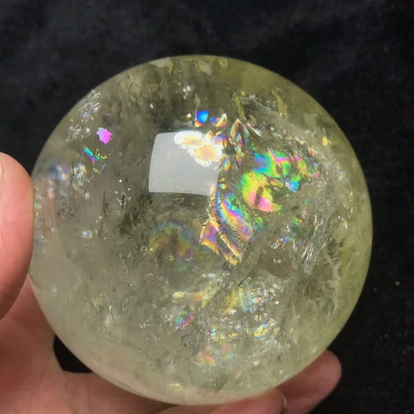 Pale yellow citrine quartz sphere with rainbows from Brazil — complete view