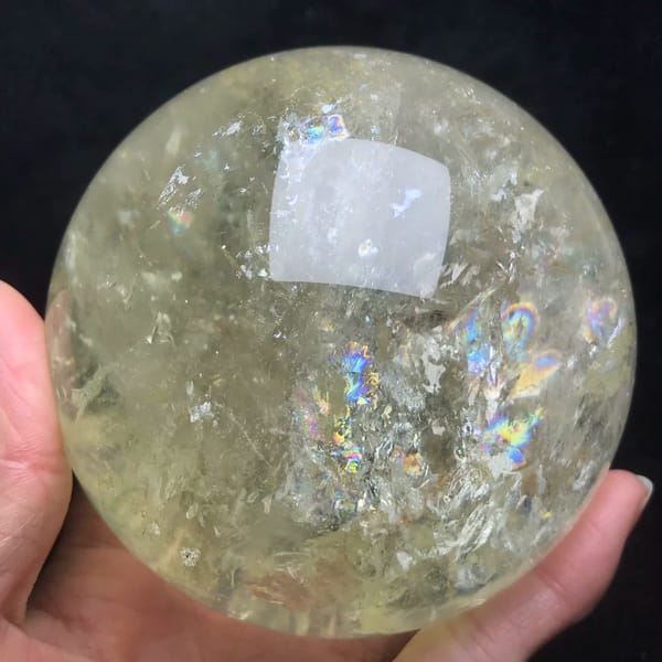 Pale yellow citrine quartz sphere with rainbows from Brazil — detail view