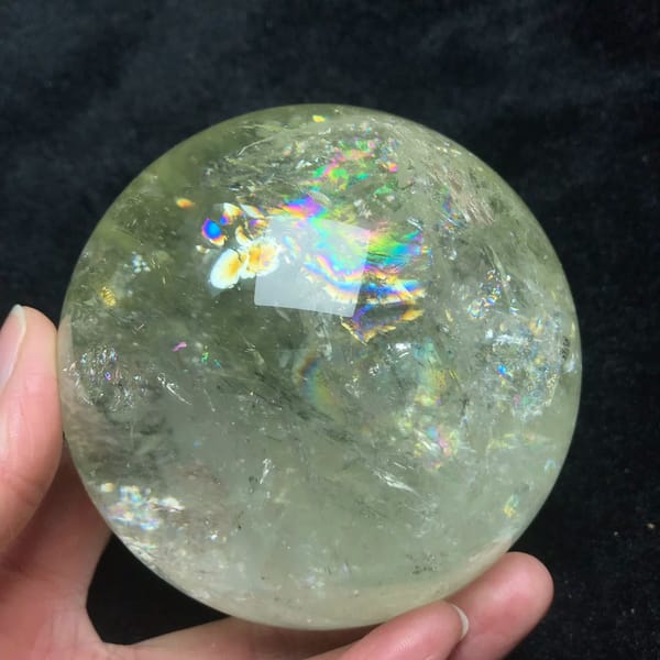 Pale yellow citrine quartz sphere with rainbows from Brazil — detail view