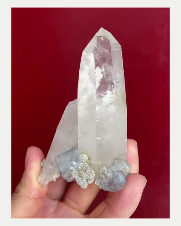 Complete front view of quartz point with pale fluorite