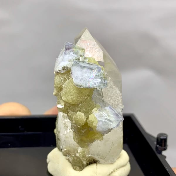 Quartz point dotted with pale blue-green fluorite from Yaogangxian — alternate view