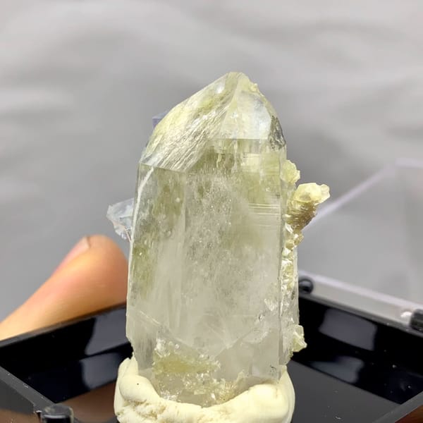 Quartz point dotted with pale blue-green fluorite from Yaogangxian — detail view