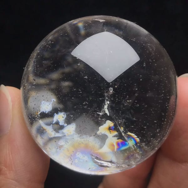 Small clear quartz sphere with dark tourmaline inclusions from Brazil — complete view