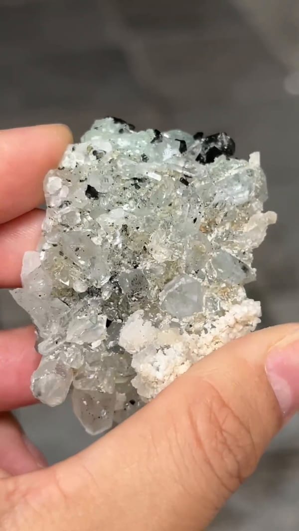 Complete reverse showing the pale quartz-bearing back of the same Zhaotong babingtonite and prehnite specimen