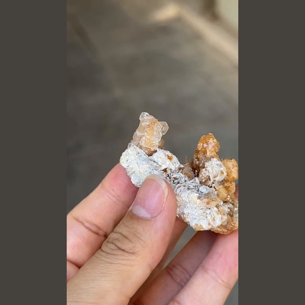 Flattened pale beryl with orange scheelite from Xuebaoding, Sichuan — complete view