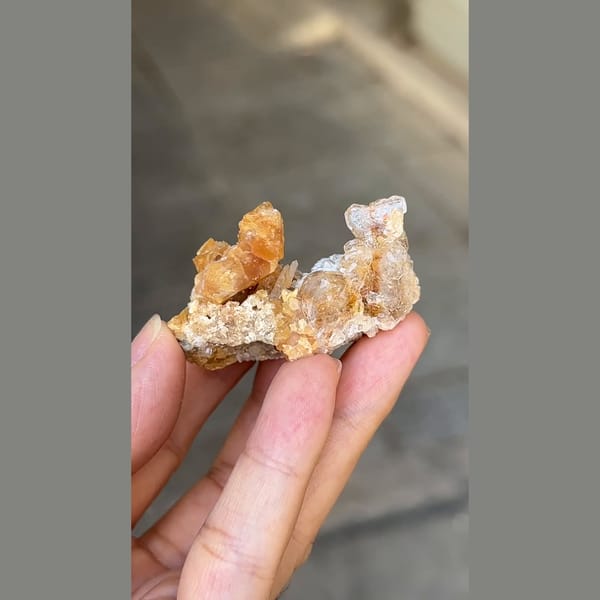Flattened pale beryl with orange scheelite from Xuebaoding, Sichuan — alternate view