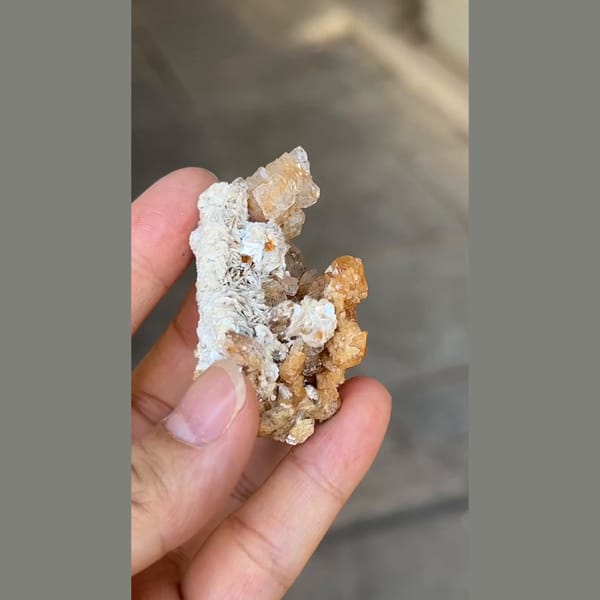 Flattened pale beryl with orange scheelite from Xuebaoding, Sichuan — alternate view