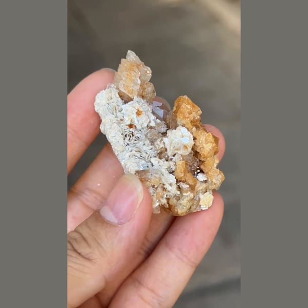 Flattened pale beryl with orange scheelite from Xuebaoding, Sichuan — detail view