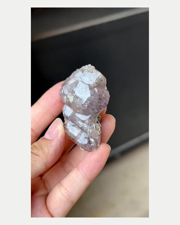Complete front view of large purple apatite with mica