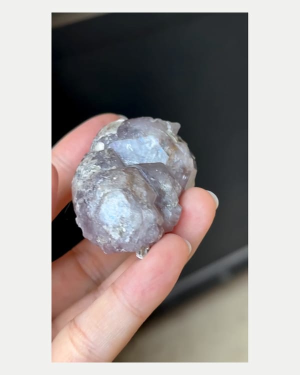 Complete left oblique view of large purple apatite with mica