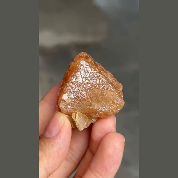 Orange-brown scheelite crystal with scaly faces from Xuebaoding, Sichuan — alternate view