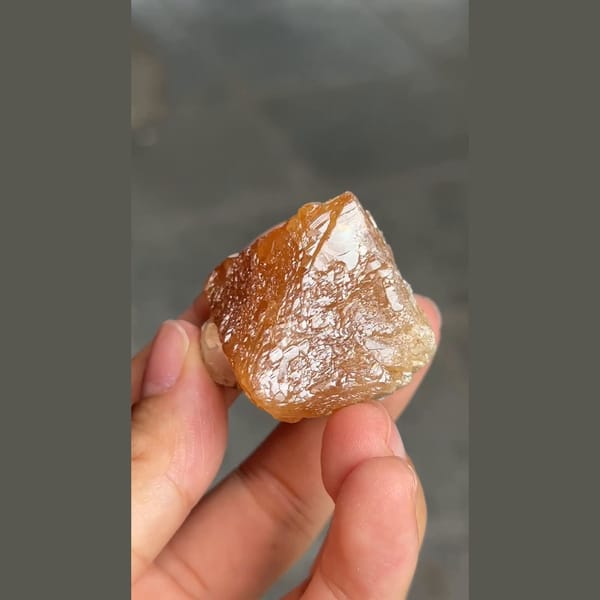 Orange-brown scheelite crystal with scaly faces from Xuebaoding, Sichuan — alternate view