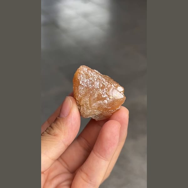 Orange-brown scheelite crystal with scaly faces from Xuebaoding, Sichuan — detail view