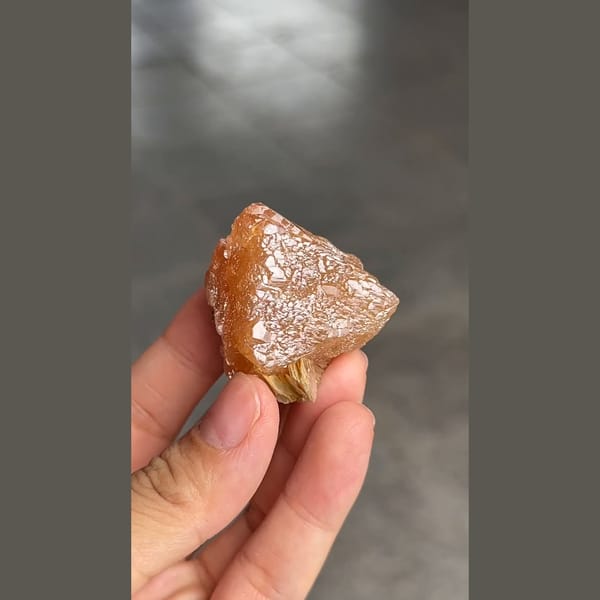 Orange-brown scheelite crystal with scaly faces from Xuebaoding, Sichuan — detail view