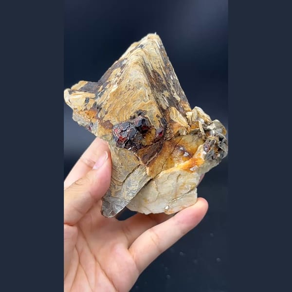 Stacked layered mica books with garnet and feldspar from Pakistan — detail view