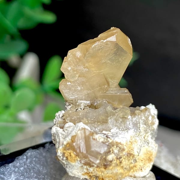Translucent yellow cerussite crystal on a pale base in a box — alternate view