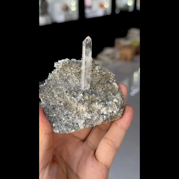 Slender clear quartz crystal on silvery mica from Xuebaoding, Sichuan — alternate view