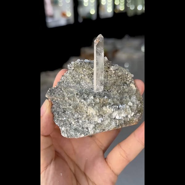 Slender clear quartz crystal on silvery mica from Xuebaoding, Sichuan — detail view