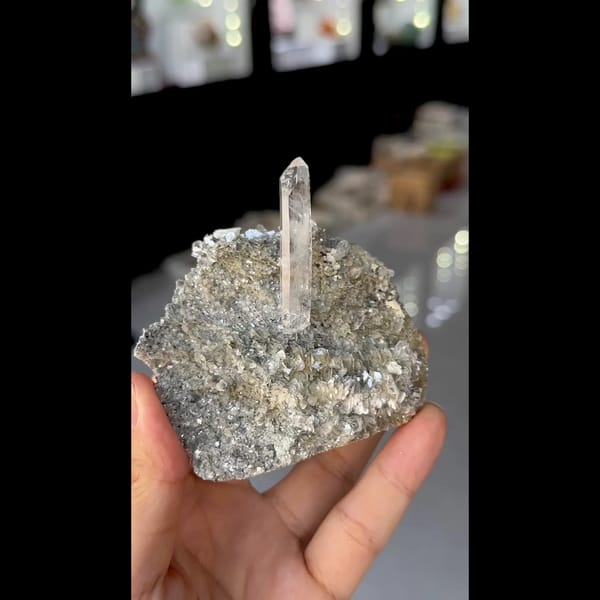 Slender clear quartz crystal on silvery mica from Xuebaoding, Sichuan — detail view