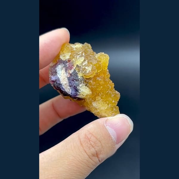 Glassy amber yellow fluorite cluster with purple zones from Henan — detail view