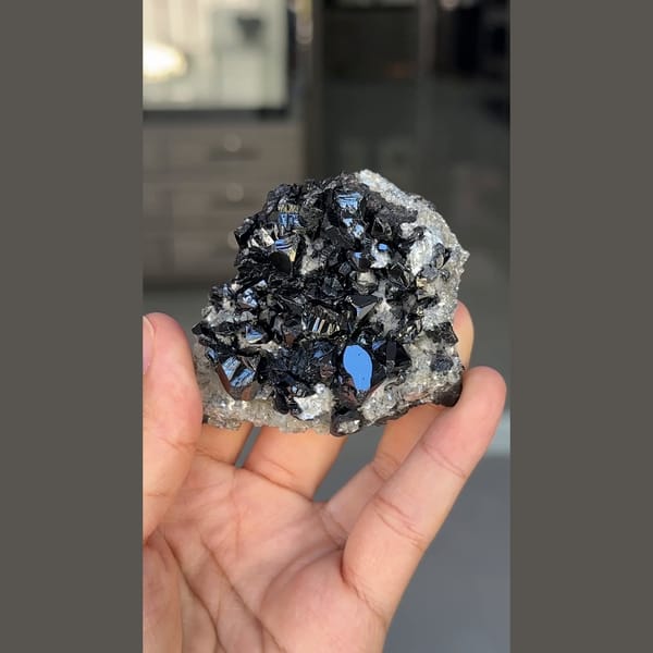 Glossy black cassiterite crystals with mica from Xuebaoding, Sichuan — complete view
