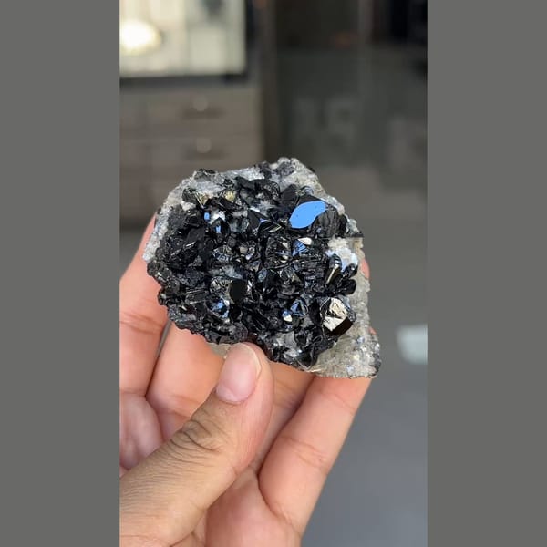 Glossy black cassiterite crystals with mica from Xuebaoding, Sichuan — alternate view