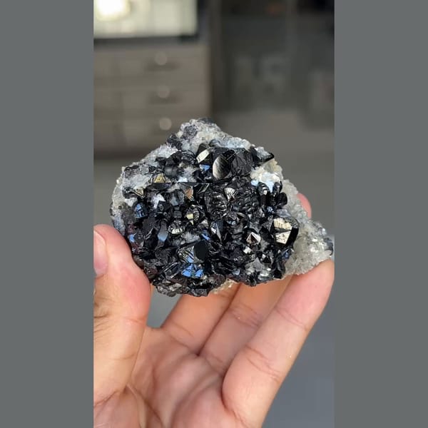 Glossy black cassiterite crystals with mica from Xuebaoding, Sichuan — alternate view