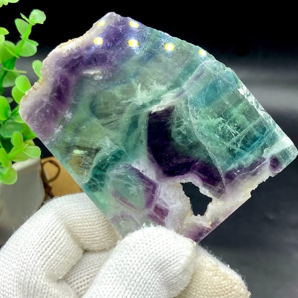 Polished fluorite slice banded in green, purple and clear — detail view