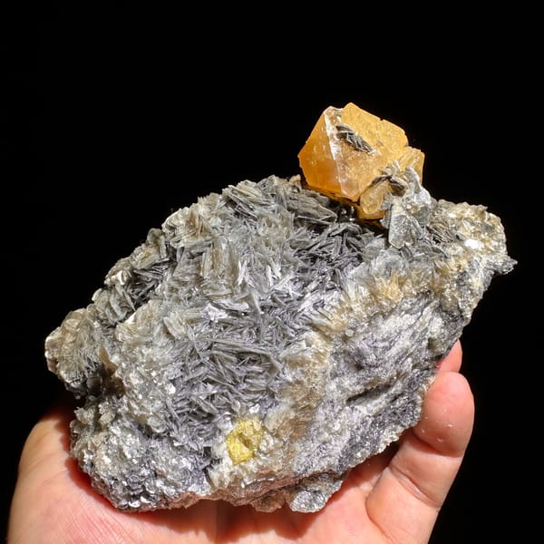 Orange scheelite crystal on silvery mica matrix from Xuebaoding — complete view