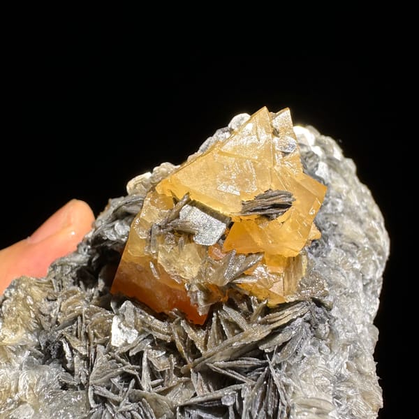 Orange scheelite crystal on silvery mica matrix from Xuebaoding — alternate view