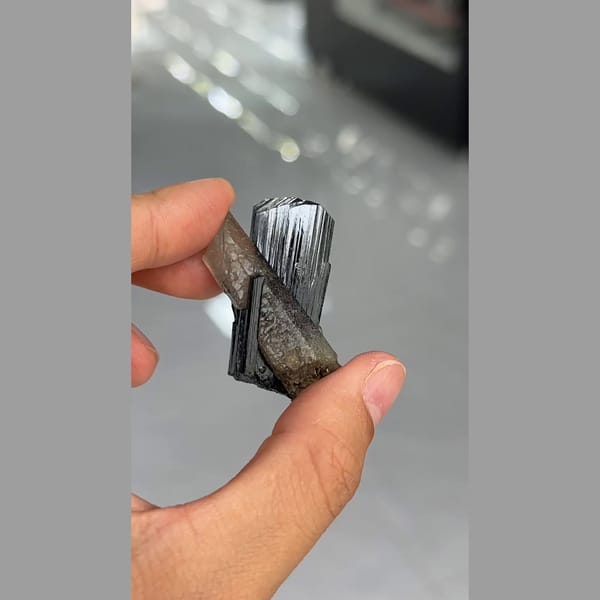 Lustrous striated black ilvaite crystals with quartz from Inner Mongolia — alternate view