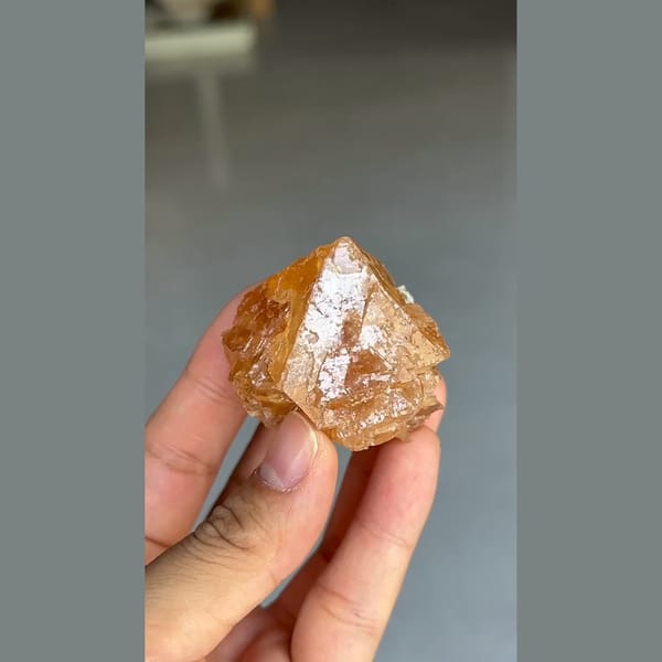 Translucent orange scheelite crystal with mica from Xuebaoding, Sichuan — complete view