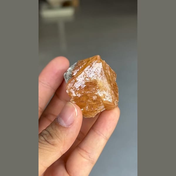 Translucent orange scheelite crystal with mica from Xuebaoding, Sichuan — alternate view