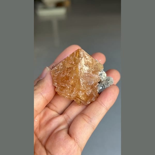 Translucent orange scheelite crystal with mica from Xuebaoding, Sichuan — alternate view