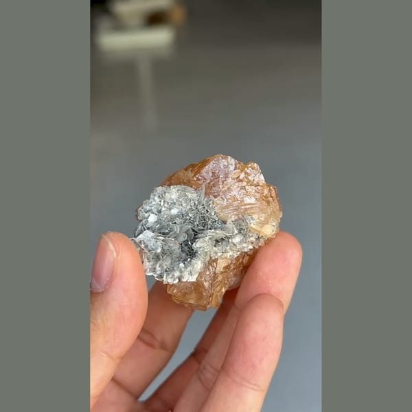 Translucent orange scheelite crystal with mica from Xuebaoding, Sichuan — detail view