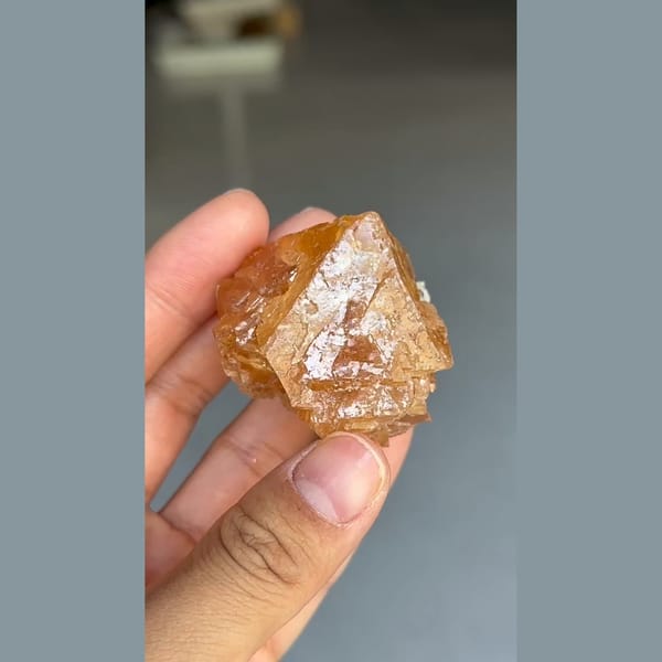 Translucent orange scheelite crystal with mica from Xuebaoding, Sichuan — detail view