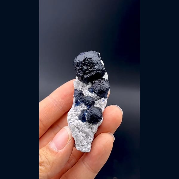 Dark blue cubic fluorite crystals on white quartz from Inner Mongolia — detail view