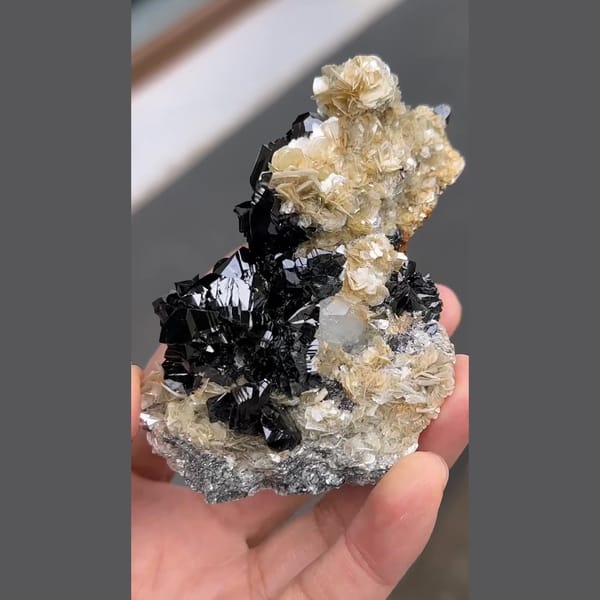 Glossy black cassiterite with aquamarine and mica from Xuebaoding, Sichuan — alternate view