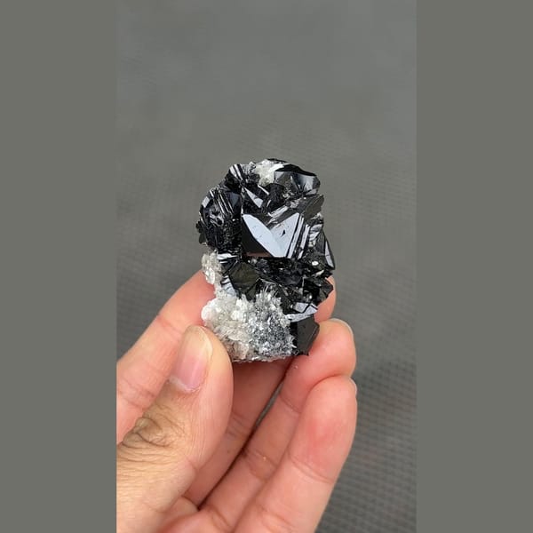 Glossy black cassiterite crystal cluster from Xuebaoding, Sichuan — alternate view