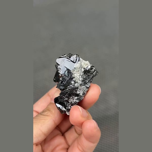 Glossy black cassiterite crystal cluster from Xuebaoding, Sichuan — detail view