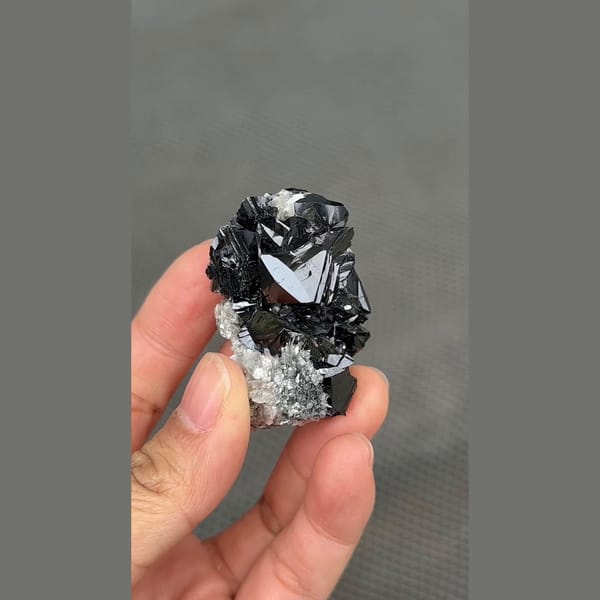 Glossy black cassiterite crystal cluster from Xuebaoding, Sichuan — detail view