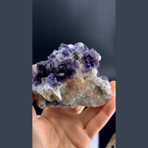 Purple phantom fluorite cubes on pale matrix from Anhui — detail view