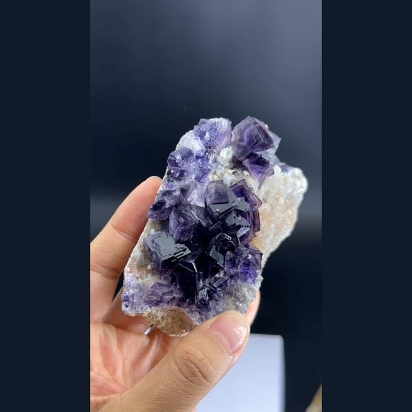 Purple phantom fluorite cubes on pale matrix from Anhui — detail view