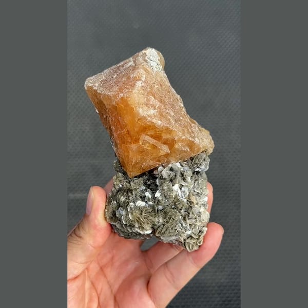 Large translucent orange scheelite on mica matrix from Xuebaoding, Sichuan — complete view