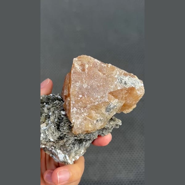 Large translucent orange scheelite on mica matrix from Xuebaoding, Sichuan — alternate view