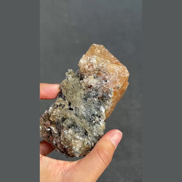 Large translucent orange scheelite on mica matrix from Xuebaoding, Sichuan — detail view